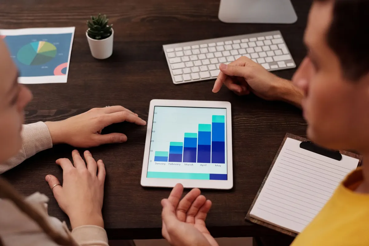 Team reviewing business growth analytics on a tablet
